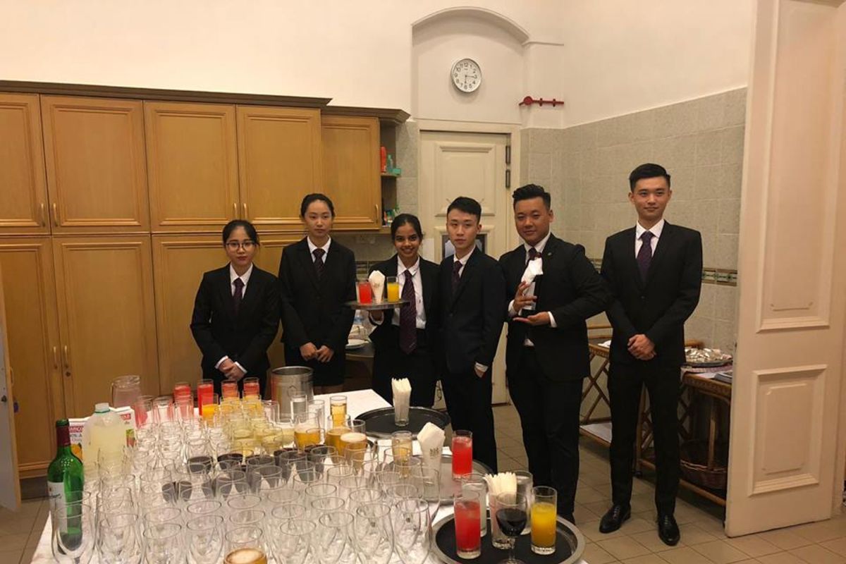 MDIS tourism and hospitality students posing for a picture in working attire.